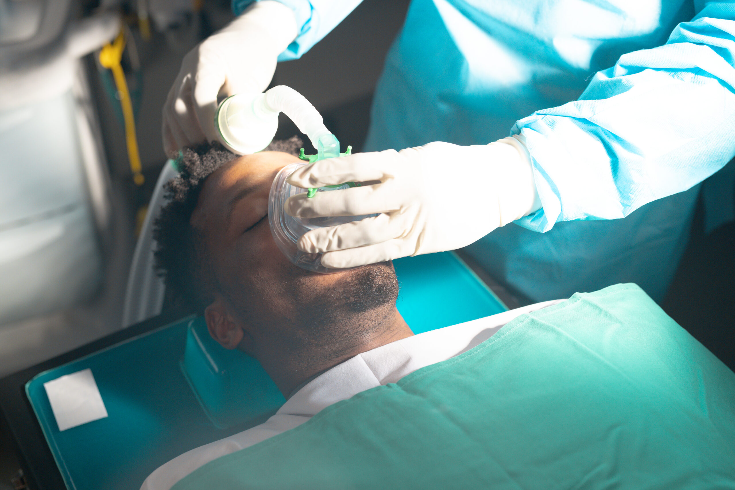Dentist examining patient's teeth during oral examination in dental clinic setting.